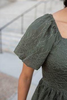 London is 5'8.5" and wearing a size small Lena 5'10" and wearing a 1X - Runs TTS with a stretch in the back, but not in the front - Square neckline - Smocked back pannel of the bodice - Beautiful green color that's fully lined - Lace overlay with dainty floral texture -Available in sizes S-3X Product Measurements*Measurements are taken from side seam to side seamwhile laying flat. Small: Length: 39.5" Bust: 15" Waist: 14" Medium: Length: 40" Bust: 16" Waist: 15"Large: Length: 40.5" Bust: 17" Wai Fitted V-neck Dress With Smocked Bodice, Short Sleeve Dresses With Elastic Shoulders For Brunch, Fitted Square Neck Dress With Smocked Back, Fitted Dress With Elastic Neckline And Puff Sleeves, Short Sleeve Dress With Smocked Back And Fitted Waist, Fitted Puff Sleeve Dress With Elastic Neckline, Fitted Dress With Elastic Shoulders And Square Neck, Fitted Dress With Smocked Bodice And Square Neck, Fitted Green Dress With Smocked Back