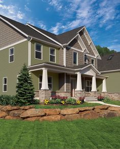 a large house with lots of windows and landscaping