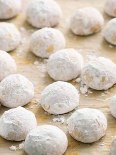 several balls of powdered sugar sitting on top of a baking sheet covered in icing