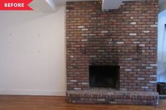 an empty room with a brick fireplace in the middle and wood flooring on the other side