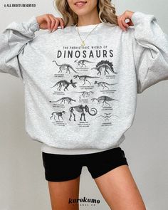 "This Unisex crewneck sweatshirt features \"The Prehistoric World of Dinosaurs\" with a set of vintage dinosaur species illustrations. It is the perfect gift for dinosaur lovers, science teachers and present / future paleontologists! Make sure to check out the other garment options below :) » O P T I O N S « ‣ Tshirt: https://www.etsy.com/listing/1246398375 » A B O U T « ‣ This item is made to order using direct-to-garment (DTG) printing technology. This digital process involves the printer inks Dark Academia Science, Adult Dinosaur Sweater, Casual Cotton Sweatshirt With Dinosaur Print, Winter Dinosaur Print Crew Neck Top, Dinosaur Shirt Vintage, Casual Dinosaur Print Crew Neck Sweatshirt, Dinosaur Print Crew Neck Graphic Tee, Dinosaur Species, Vintage Dinosaur