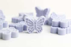 a close up of many different shapes and sizes of soaps on a white surface