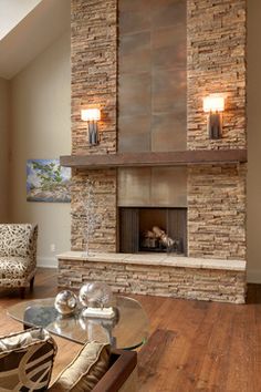 a living room with a fire place in the center and two lamps on either side