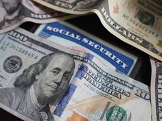 several hundred dollar bills with social security written on them