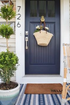 a blue front door with a basket hanging on it