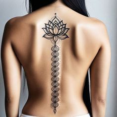 the back of a woman's body with a tattoo design on her lower back