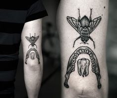 two people with tattoos on their arms, one has a beetle and the other has an elephant