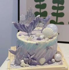 there is a cake decorated with sea shells