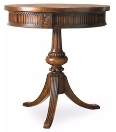 a round wooden table with an ornate design