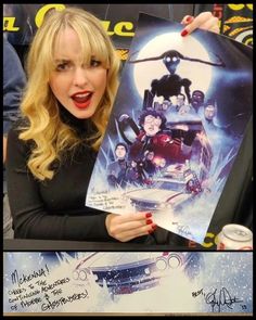 a woman holding up a movie poster in front of her face