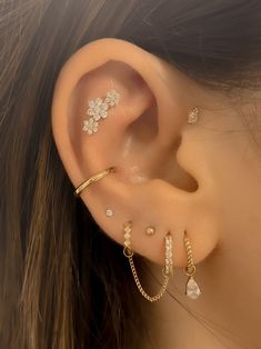 a close up of a person's ear with three different types of piercings