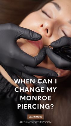 a woman with black gloves on her face and the words, when can i change my monroe piercing?