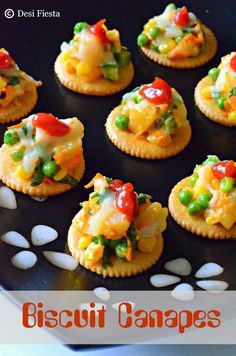 small crackers with various types of food on them and the words biscuit canapes written below