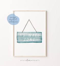 a print with the words no wake zone hanging from a string on it's wall