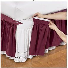 the bed skirt is being pulled over by two hands