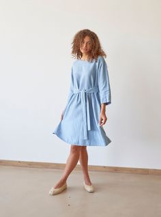 "PRODUCED in 3-5 days FAST & FREE shipping with DHL Express Courier -10% for all items with code \"FAVOURITE\" Featuring a steel blue hue and relaxed silhouette, this dress is a true secret. With a loose silhouette, it looks breezy and bohemian.  And when styled with an adjustable belt it looks elegant and graceful. Trust your feelings and choose your favorite image!  Details: - 100% Linen - Pure linen fabric - 3/4 sleeves - Boat neck - Two side pockets - Relaxed silhouette - Above knee length - Adjustable belt - Model's height is 180 cm / 5'11'' wears size M - Code: E9018-L532-126 The dress is available in other colors. You can find them in the gallery. If you want to order the dress in another color, please specify it in the personalization field. Sizing: This garment is true to size, an Light Blue Linen Dress For Spring, Blue Linen Knee-length Dress With Relaxed Fit, Spring Blue Linen Dress For Daywear, Spring Linen Belted Dress, Light Blue Linen Dresses For Spring, Blue Knee-length Linen Dress With Relaxed Fit, Blue Knee-length Belted Summer Dress, Relaxed Fit Blue Linen Knee-length Dress, Casual Blue Linen Dress For Work