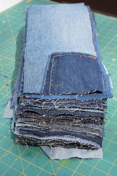 several pieces of blue jeans are stacked on top of each other