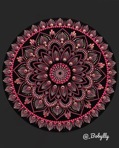 a pink and black circular design with lots of dots in the shape of a flower