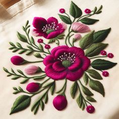 an embroidered bag with pink flowers and green leaves