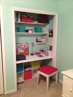 a room with a desk and shelves filled with books, toys and other things in it