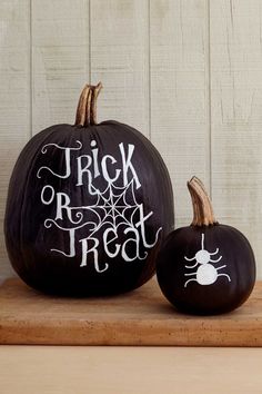 an open book with two black pumpkins on it and the title trick or treat written in white