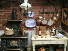 an old fashioned stove with many pots and pans on it