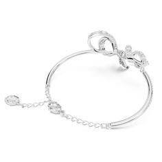 The most beautiful way to wrap your wrist, this bow-inspired bangle is one of the shining highlights of the Volta family. The bangle itself features a pavé of clear crystals, while the central ribbon design is elegantly adorned with more clear stones using the chattonage technique. Wear this rhodium plated piece of jewelry to create a look of modern elegance, or present it to someone as a gift on a special occasion. Article no.: 5647563 Collection: Volta Maximum length: 6 3/4 inches Motif length Evening Crystal Bracelet, Adjustable Bow Jewelry For Evening, Elegant Adjustable Bracelet With Bow, Elegant Adjustable Bracelet With Bow Detail, Elegant Adjustable Bracelets With Bow Detail, Bow Bracelet, Ribbon Design, Clear Stone, Clear Crystals