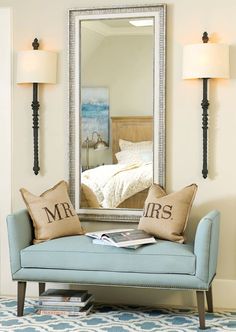 a blue couch sitting in front of a large mirror