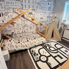 a child's bedroom with a teepee tent bed and rugs on the floor