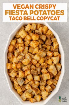 a white bowl filled with fried potatoes on top of a gray counter next to a sign that says vegan crispy fiesta potatoes taco bell copy