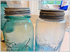 two blue mason jars sitting next to each other