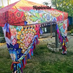 an elaborately decorated tent in the middle of a field