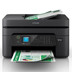 an epson printer sitting on top of a pile of paper next to it's tray