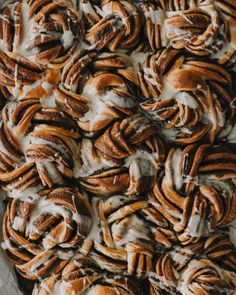 cinnamon rolls covered in icing and drizzled with icing