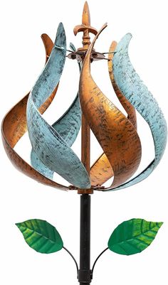 a metal sculpture with leaves on it