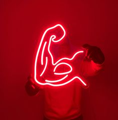 a person holding a neon sign in their hands