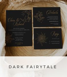 three black and gold wedding cards on top of a wood slice with the words dark fairy tale