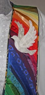 a colorful tie with a white dove painted on it's side and rainbow colors