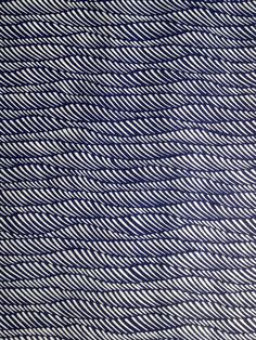 a blue and white rug with wavy lines