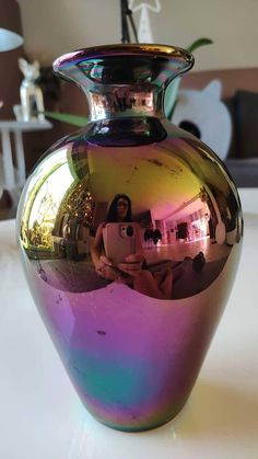 a large shiny vase sitting on top of a table