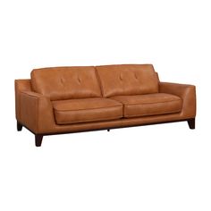 a brown leather couch sitting on top of a white floor