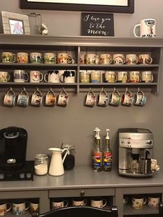 a coffee bar with mugs on the shelves