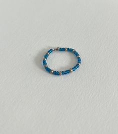 This stackable ring is made with blue and silver seed beads strung onto silver wire. Great for pairing with other rings, simple and dainty design. Bead Stringing, Beaded Rings, Stackable Rings, Silver Wire, Blue And Silver, Seed Beads, Favorite Jewelry, Jewelry Rings, Beauty Book