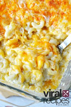 macaroni and cheese casserole in a glass dish with a serving spoon