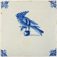 a blue and white tile with a bird sitting on it's back legs,