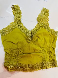 This is the perfect layer to add under a tank or off shoulder. I wear mine with a bra to over my straps with a cute lace detail but keep the support I need. Fit: O/S fits most, Anna is a 36 C/D and wears this size Fabric: 92% Nylon, 8% Spandex Green Camisole Crop Top With Built-in Bra, Spring Stretch Cami Bra, Summer Lace Stretch Bra, Trendy Stretch Camisole With Lace Trim, Stretch Lace Bra For Summer, Lace Fitted Tank Top With Built-in Bra, Stretch Lace Top With Built-in Bra, Summer Bra With Lace Top, Stretch Lace Camisole Crop Top