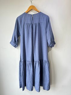 Beaton Cornflower Blue Linen Dress. The prettiest color! Perfectly flowy with tiered pleats to add some texture and volume. Button closure short sleeves and big pockets. Machine wash cold and line dry, marked size Sm. Approximate measurements:Underarm to underarm: 18"Length: 40" Relaxed Fit Short Sleeve Dresses With Ruffle Hem, Blue Short Sleeve Pleated Maxi Dress, Spring Tiered Dress With Pockets, Ruffled Short Sleeve Relaxed Fit Dress, Blue Short Sleeve Tiered Dress With Ruffle Hem, Casual Blue Midi Length Tiered Dress, Casual Blue Midi Tiered Dress, Casual Blue Tiered Dress For Daywear, Casual Blue Dress With Pleated Hem