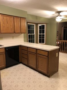 an empty kitchen with wooden cabinets and white counter tops is pictured in this image from the inside