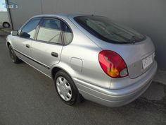 a silver car parked in front of a building