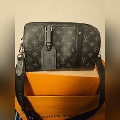 This Is The Louis Vuitton City Keepall Purchased From The Men's Section But It Can Definitely Be Unisex ! Please Review Pictures As They Best Showcase The Item. Also, Details And Specifications Or In A Picture Above . 100% Authentic Never Used It's Micro Chipped & I Have Proof Of Authenticity/Purchase Plus The Strap Is Authentic As Well. Since It Came With The City Keepall (For Those Of You Who Don't Know). Price Is Very Firm Please Do Not Comment On My Listing Talking About Trading Let's Keeps Luxury Gray Shoulder Bag, Black Monogram Canvas Shoulder Bag For Business, Business Black Monogram Canvas Shoulder Bag, Luxury Gray Business Bags, Luxury Black Monogram Canvas Shoulder Bag, Luxury Gray Shoulder Bag With Dust Bag, Luxury Shoulder Bag With Gunmetal Hardware, Black Monogram Canvas Shoulder Bag For Evening, Black Monogram Canvas Evening Shoulder Bag